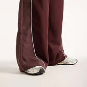 NEW BALANCE Trackside woven pant cherry leather